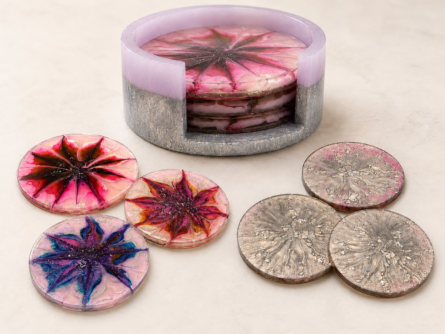 Pink and silver resin coasters with petal burst patterns in a lavender holder
