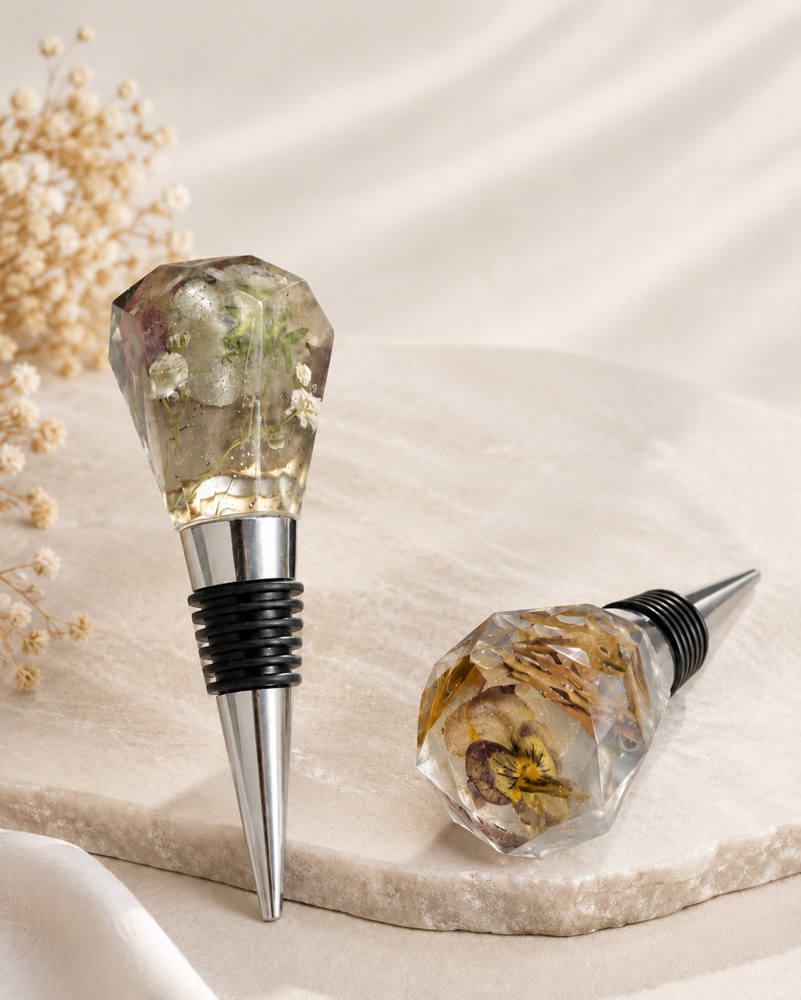 Faceted resin wine stoppers with pressed flowers and gold flake