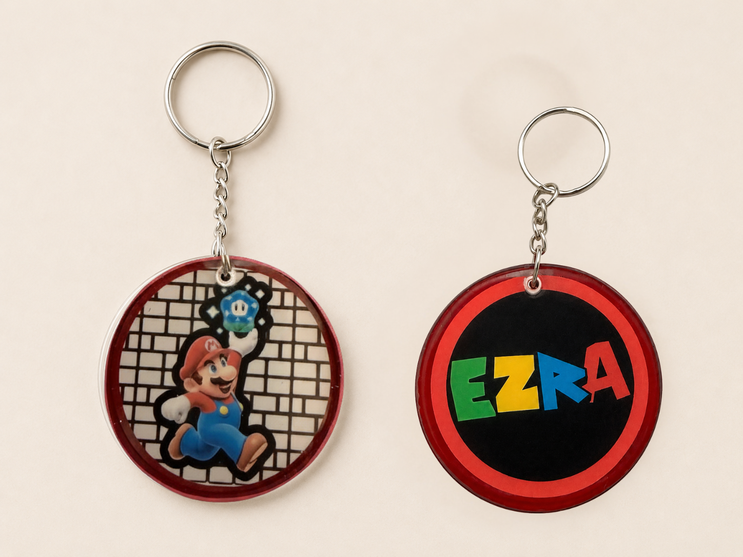 Red personalized keychain with Ezra name and game-inspired artwork
