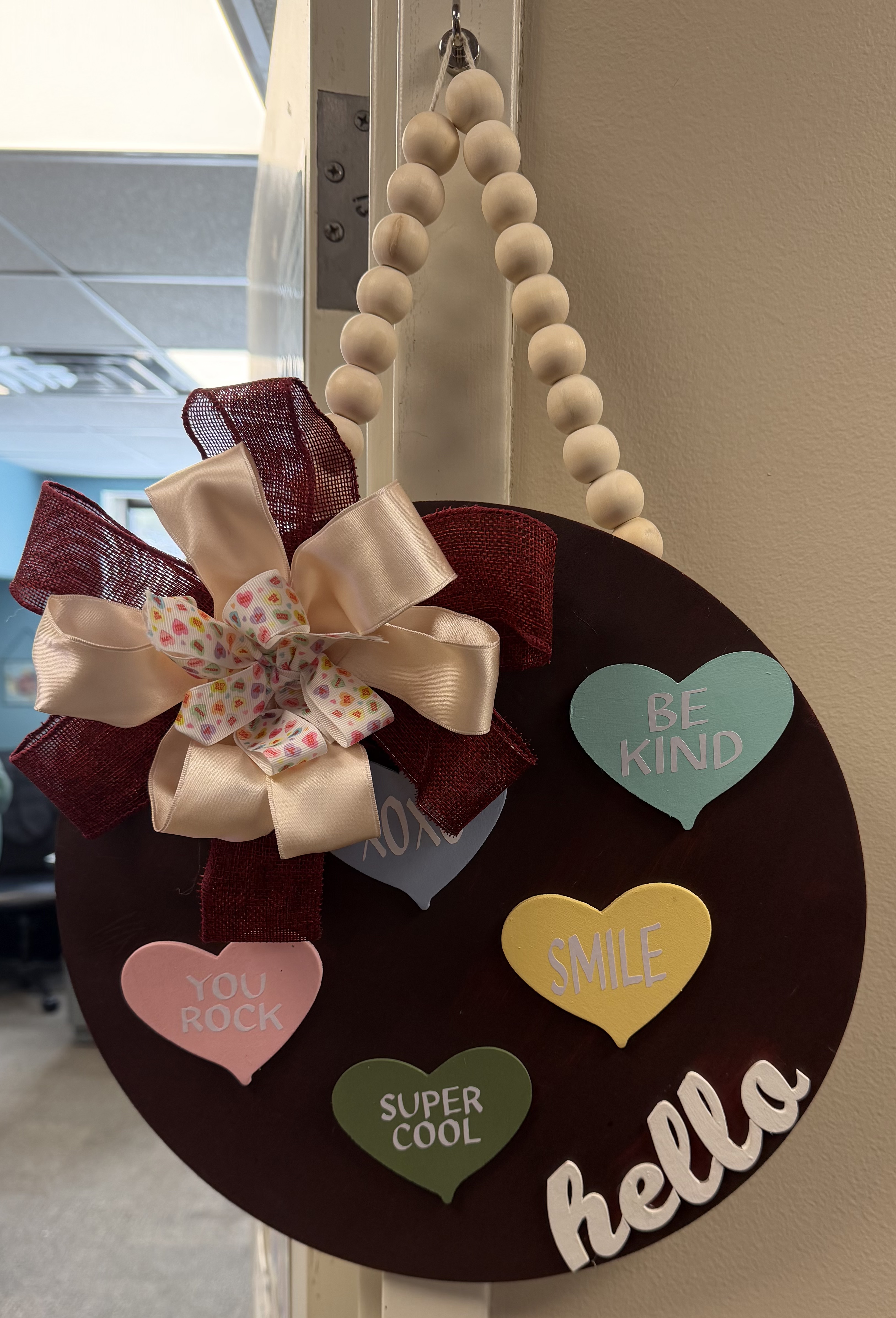 Hello door hanger with beaded strap and heart accents