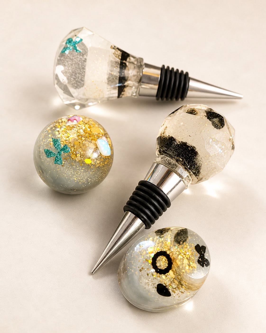 Black, gold, and teal flake resin wine stoppers